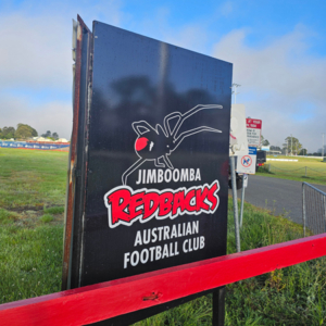 An ACP sign for Jimboomba Redbacks AFC with their logo on it