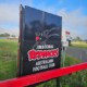An ACP sign for Jimboomba Redbacks AFC with their logo on it