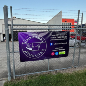 Jimboomba Gymnastics - Vinyl Banner A vinyl banner for Jimboomba Gymnastics, installed to a fence. The banner has their logo and contact details.