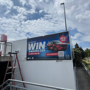 The Lion Richlands - Mazda CX5 banner Vinyl banner that says "Win a Mazda CX5 with The Lion Richlands'