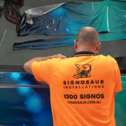 Signosaur Installations - Tadano Hybrid Crane Wrap A Signosaur Installations team member installing the wrap for Tadano's hybrid crane.
