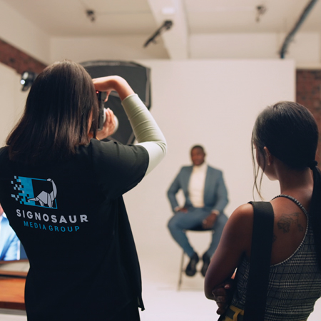 Signosaur Media Group woman photographing a portrait.