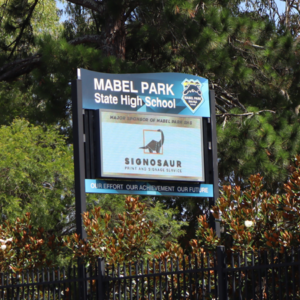 The LED screen on the fence boundary line for Mabel Park State High School displaying 