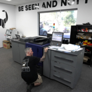 A Signosaur staff member working with a digital printer